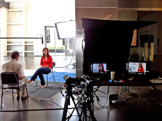 A man interviewing a woman on video